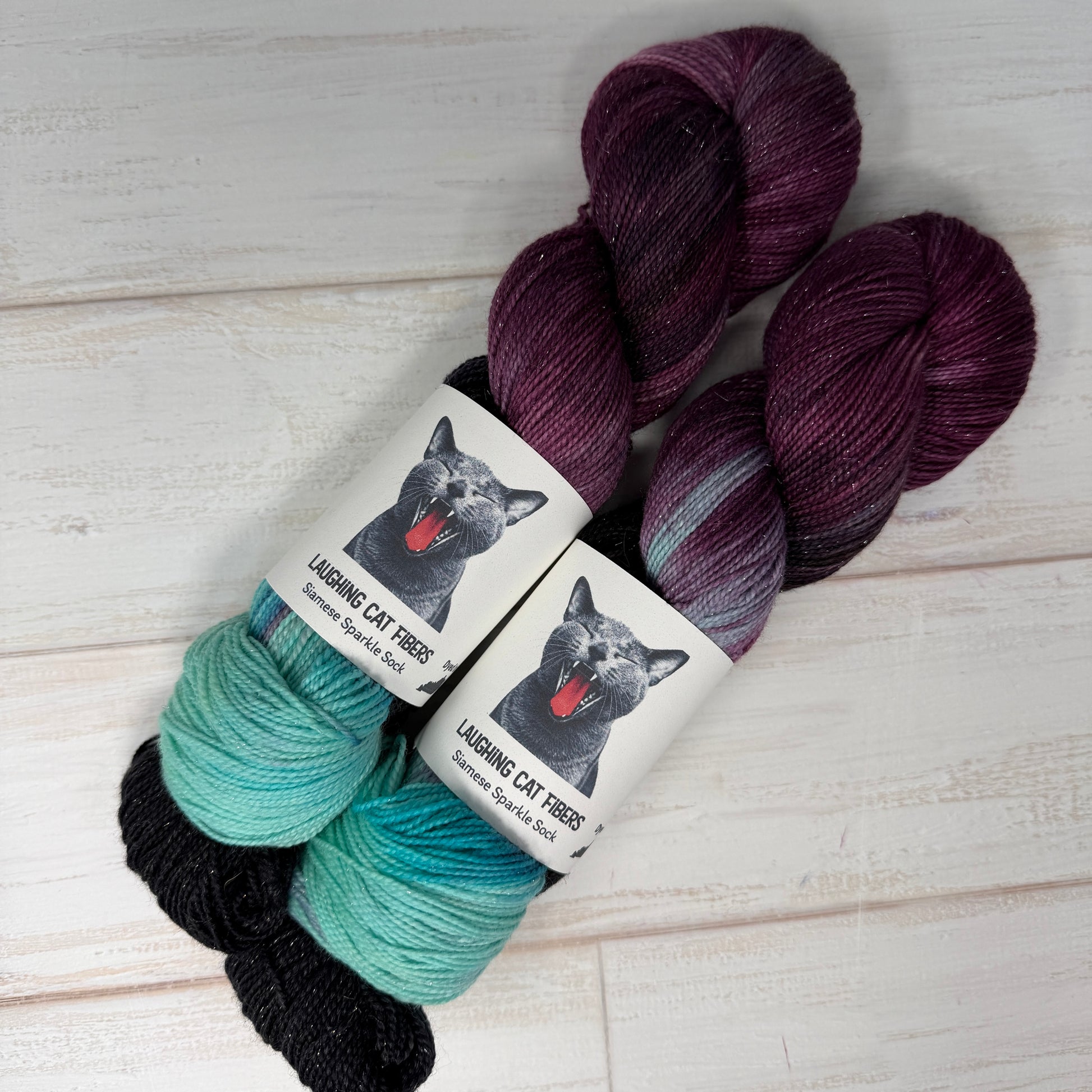 two skeins of sparkle sock yarn dyed in the To Kill a Mockingbird cololrway by Laughing Cat Fibers