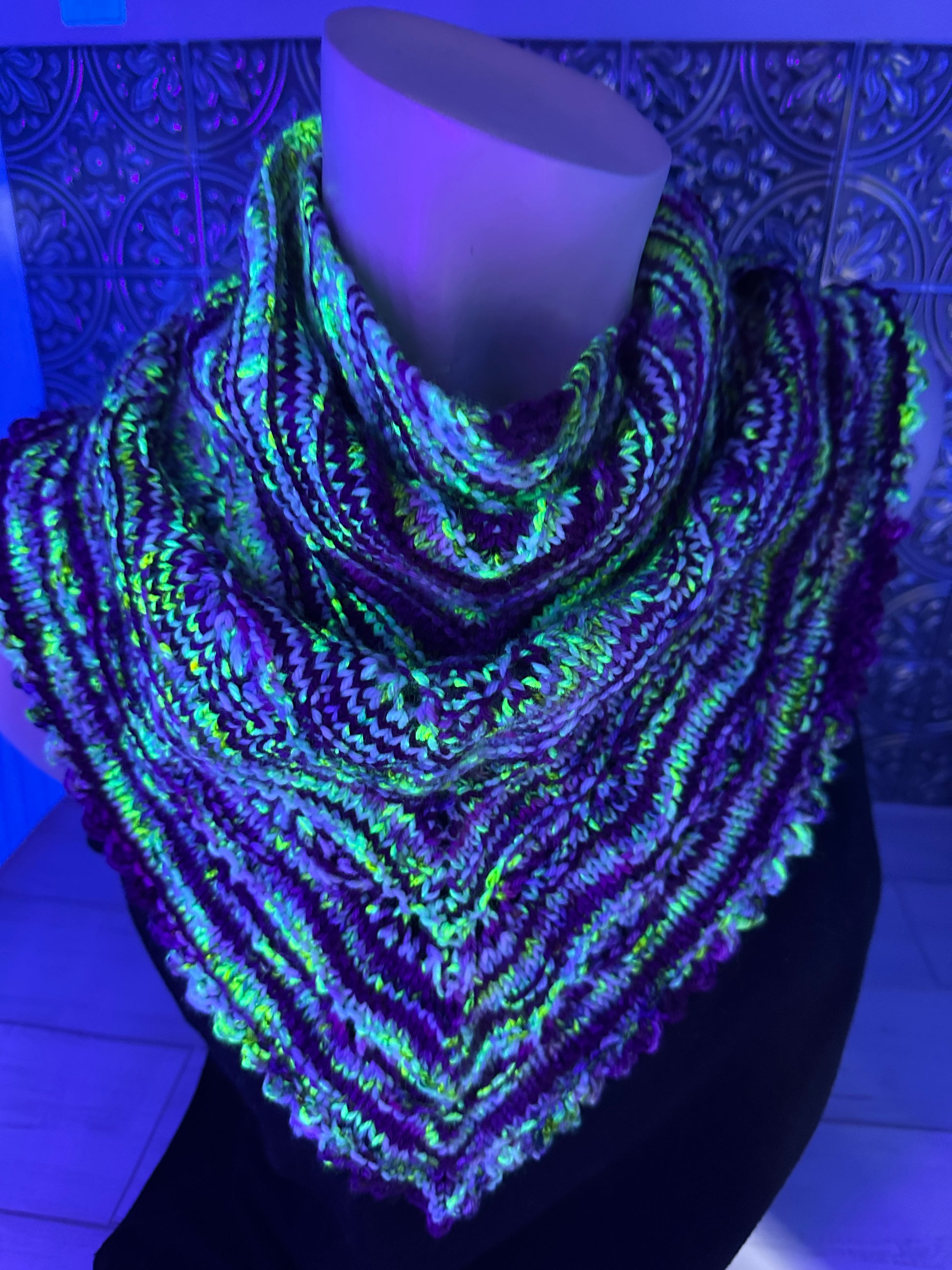 Glowing multicolored fabric under black light on a textured surface
