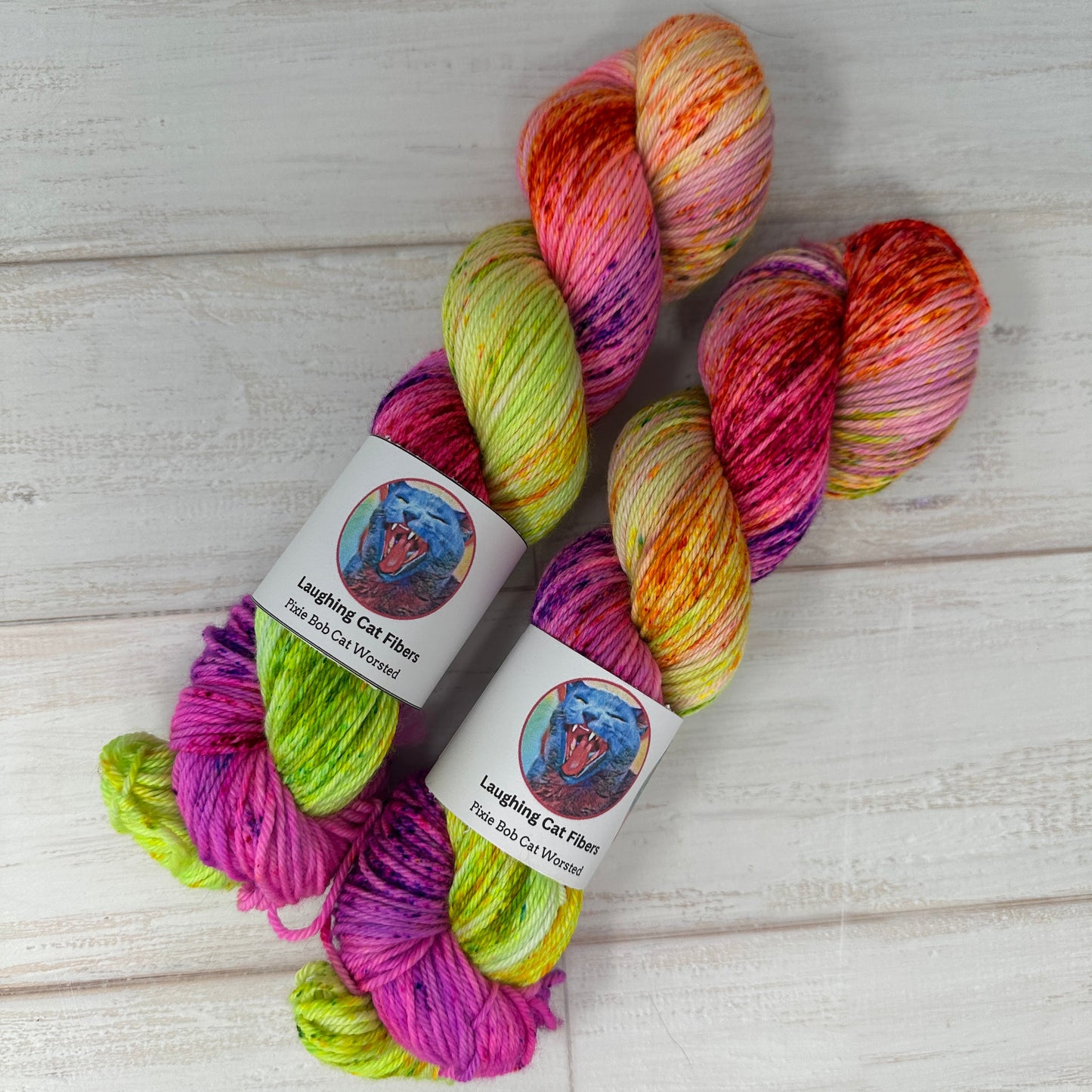 Multicolored yarn skeins with labels on a light wooden surface
