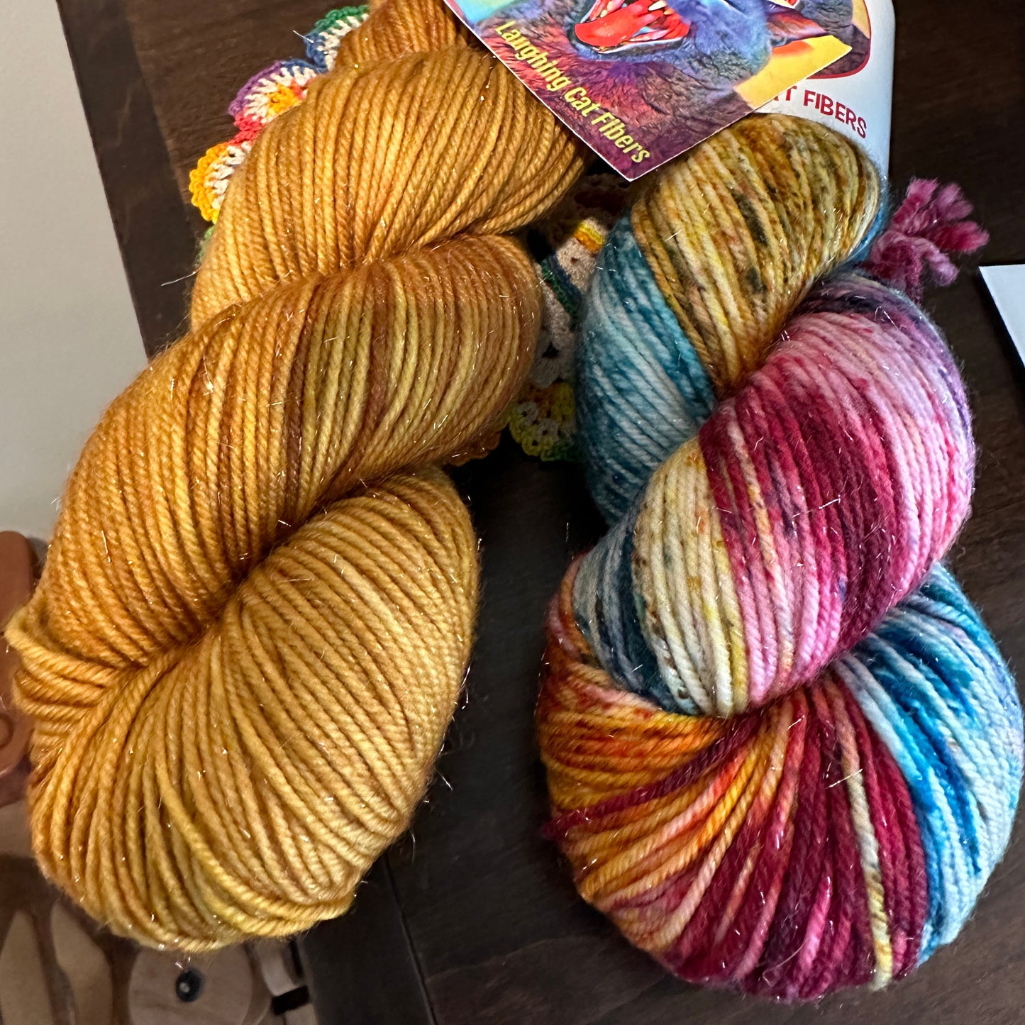 two complimentary skeins of hand dyed yarn by Laughing Cat Fibers