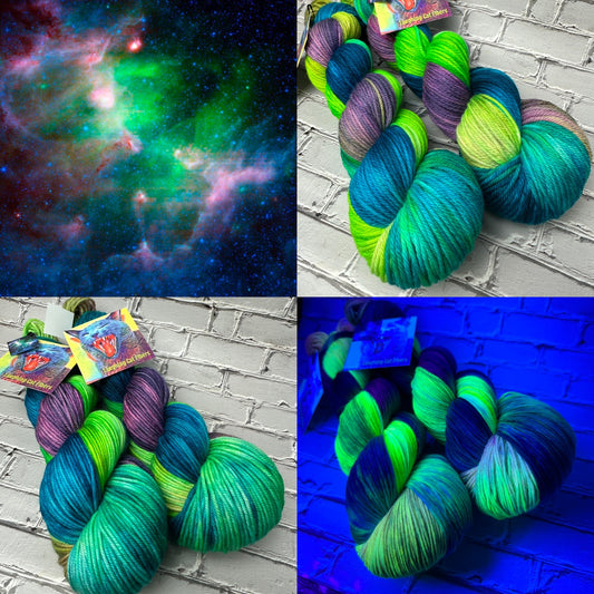 A collection of yarn skeins in colors resembling a nebula, displayed alongside a visual of a starry space nebula.