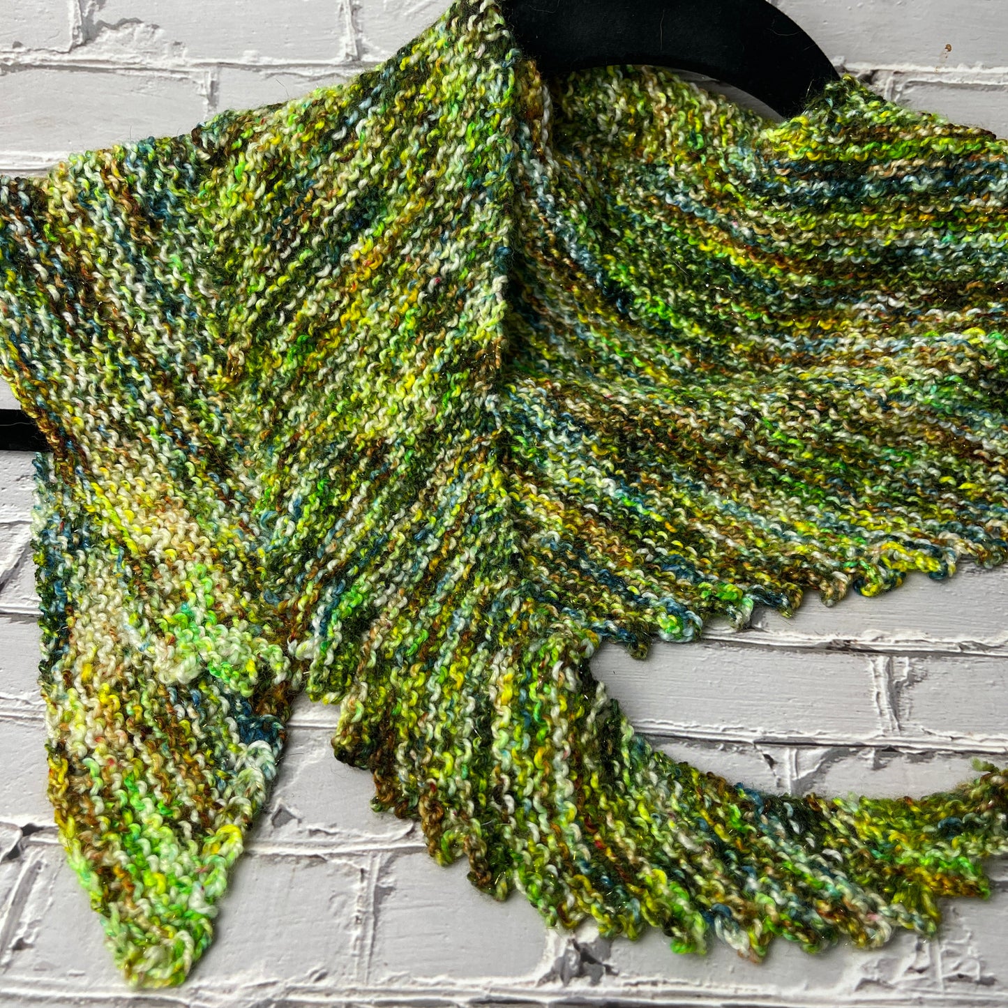 image of a knitted shawlette in yarn hand dyed by Laughing Cat Fibers in their Lake Erie Algae Bloom colorway 