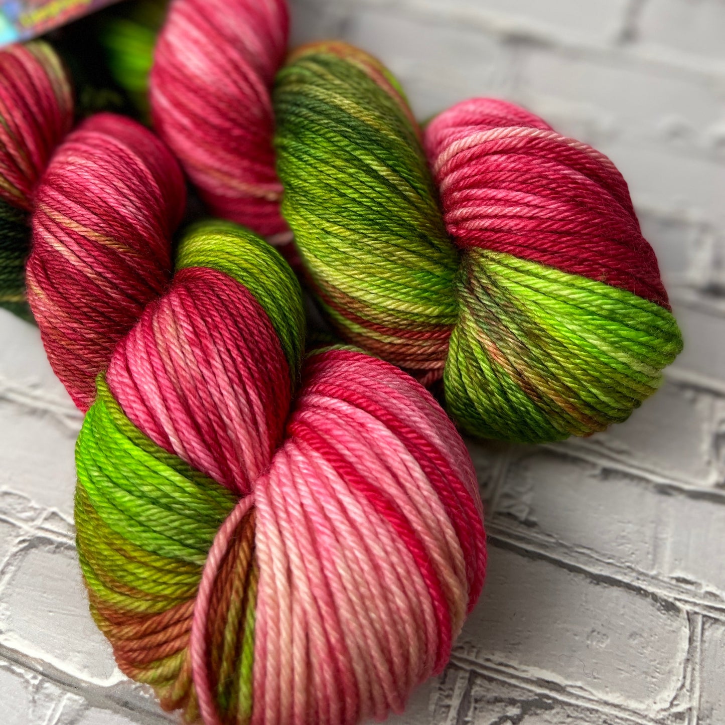 two skeins of worsted hand dyed yarn by Laughing Cat Fibers in their Viva la Vida colorway