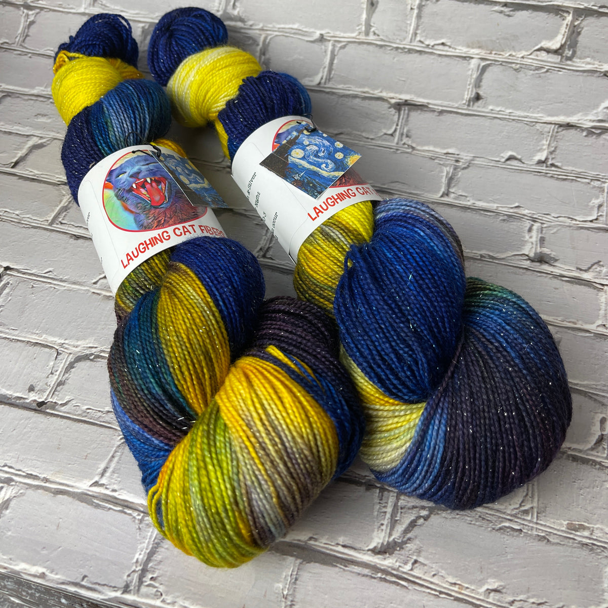 two skeins of sparkle sock yarn hand dyed by Laughing Cat Fibers in their Jenny's Starry Night colorway 