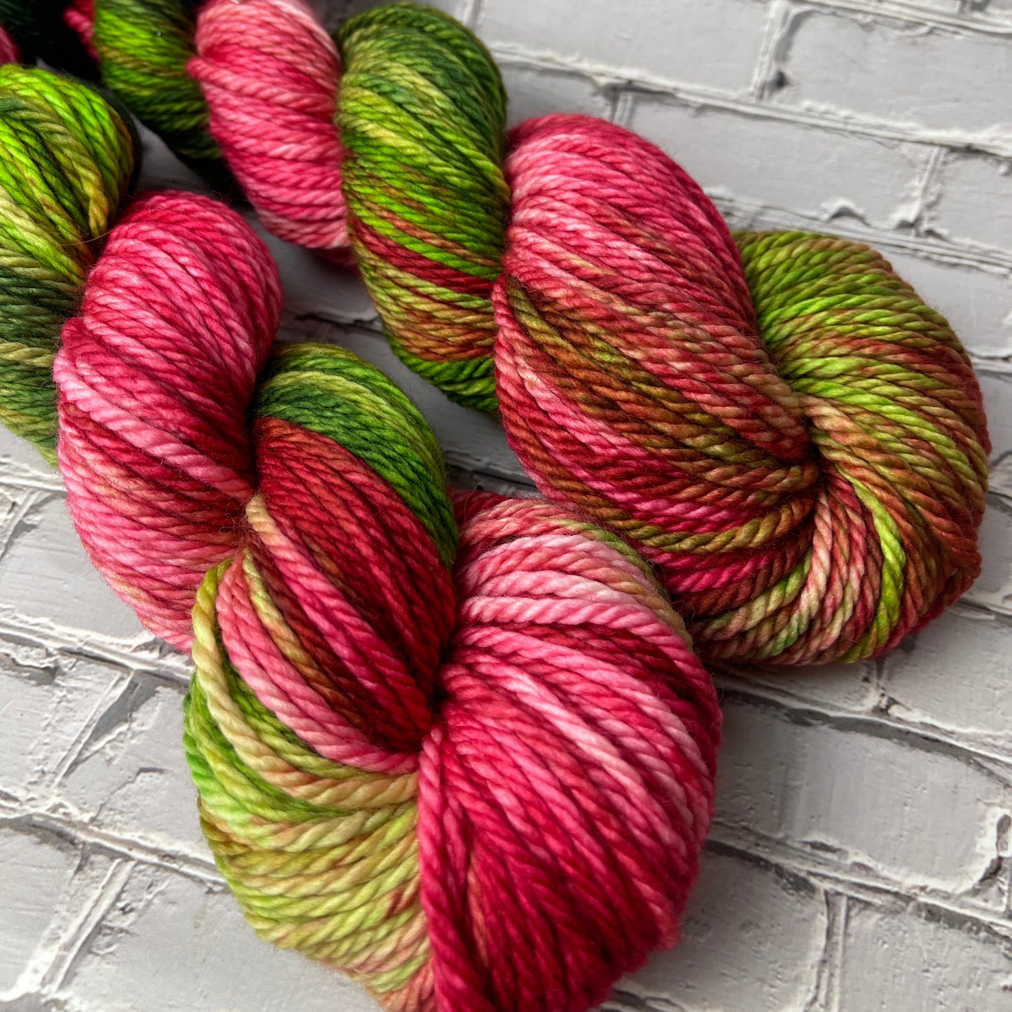 two skeins of hand dyed bulky yarn by Laughing Cat Fibers in the Viva la Vida colorway 